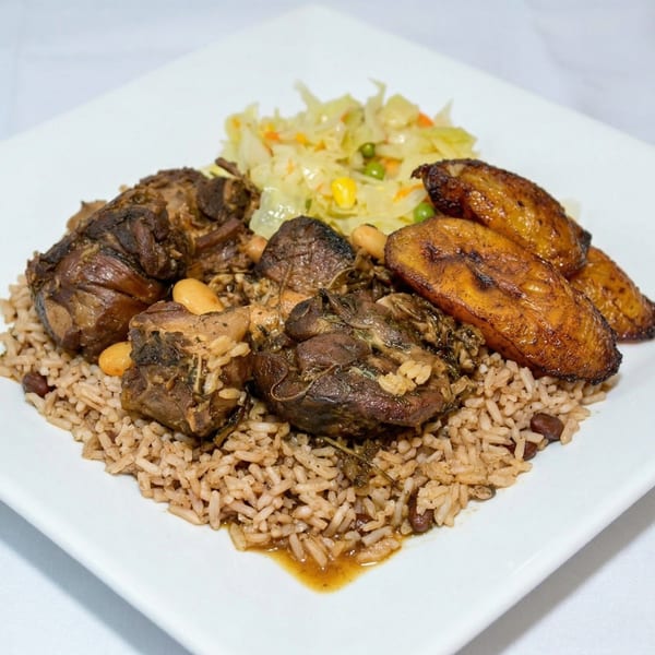 Oxtail stew with rice and peas, fried plantains, and steamed cabbage on a white plate.